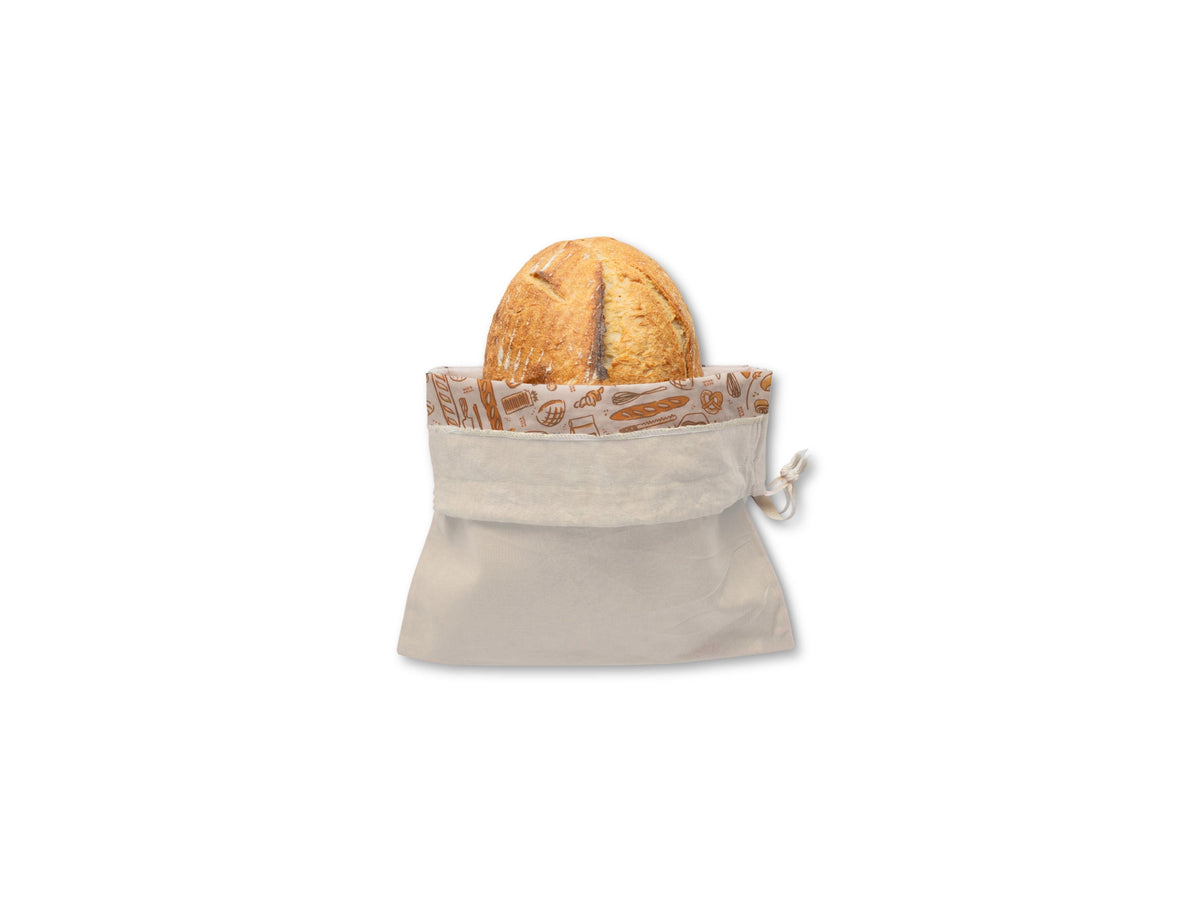Bee's Wrap Bread Bag with loaf of bread on a white background